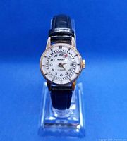 Front view of the vintage Nordic Swiss women's watch showing the white dial with black Arabic numbers, rotating bezel with crystal-like stones, and new black leather strap.