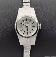 Close-up photo of silver-tone Seiko quartz women's wristwatch face showing dial and hands