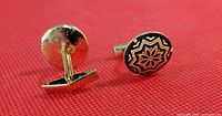 Pair of Damascene Toledo style men's cuff links with black and gold floral star design