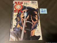 Front cover of the New X-Men comic book showing the full cover art and the autograph by Frank Quitely.