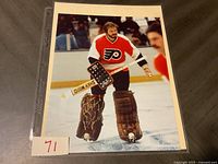 Full view of the autographed photo showing Bernie Parent in goalie gear on ice, holding Sher-Wood stick, signed with personal inscription.