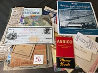 Full view of the vintage ephemera lot showing check, agrico memo book, harborfest event poster, tickets, and various papers