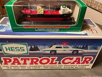 2002 Miniature Hess Voyager ship in original packaging on top of Hess Patrol Car box
