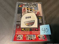 Front view of the sealed Starrett Digitape 16 ft measuring tape packaging showing the tape case, brand, and usage instructions.
