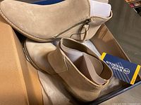 Pair of new White Mountain beige suede ankle boots in size 8 shown in the shoe box with logo.