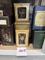 Stack of cream colored Boyd's Bears boxes from The Bearstone Collection and Le Bearmoge Collection, showing boxed bear ornaments with plastic windows.