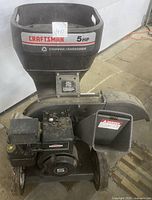 Front view of the Craftsman chipper shredder showing the hopper with 5HP label and engine.