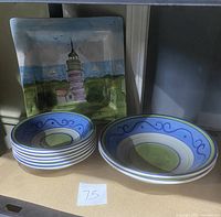 Six small Basiq bowls stacked together with two large Basiq bowls alongside Mesa lighthouse platter behind