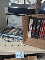 Overview photo showing the Michael Jackson Ultimate Collection presentation metal case next to a box containing the True Blood DVD sets.