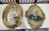Two oval-shaped frames side by side on a white surface, containing vintage portraits of a woman and a man.