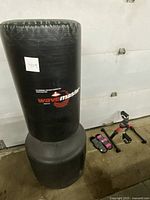 Wavemaster portable training bag with base, two wrist weights, and stationary pedals with counter placed on the floor.