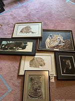 Six large framed big cat art pieces laid out on floor showing variation in images and frame styles