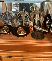 Full view of the Egyptian figurines and collectibles displayed on wooden surface in front of a mirror