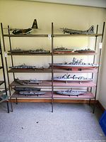 Full view of metal shelving unit with multiple shelves, showing empty shelf surfaces and metal frame