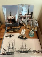 Photo showing entire nautical decor set including model ships, framed photos, windmill and decorative hull-like pieces