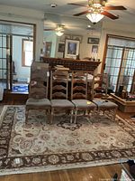 Wide view of the full rug with chairs placed on top, showing the overall design and size of the Persian hand made wool rug.