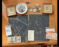 Overview of Vietnamese currency set including banknotes, coins, framed stamps, decorative plate on a wooden surface