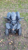 Top front view of small black kids 4-wheeler ATV showing handlebars, seat, and tires.