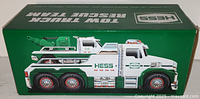 Side view of the green box containing the Hess Tow Truck Rescue Team Truck, showing detailed truck illustration and branding.