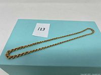 Full view of chain laid on blue box