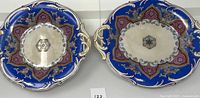 Top view of both porcelain bowls showing star-like multicolored design, golden rims, and overall pattern.