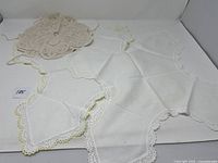 Photo of all three vintage bread basket cozies together showing their different shapes and lace details.