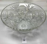 Clear glass bowl with EAPG Star of David pattern, showing overall shape, scalloped edges, and pressed glass star design