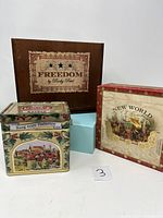 Full view of four boxes and tins showing design and labels, including Freedom by Rocky Patel wooden cigar box and metal tins decorated with artwork