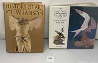 Two large art books standing side by side: 'History of Art' by H.W. Janson and 'The Porcelain Art of Edward Marshall Boehm' by Reese Palley.