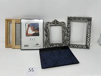 Full lot of 6 picture frames varying in material and style displayed on a white surface.