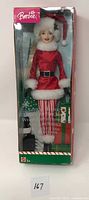Front view of Santa's Helper Barbie doll in original packaging showing doll dressed in red and white Santa outfit.