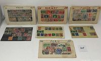 Six packets of postage stamps from various countries, displayed on labeled cards and one plastic sleeve, showing assorted eras and designs.
