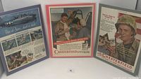 Three vintage cigarette advertising posters from the 1950s, two Chesterfield and one Camels, framed or matted, 11x14 inches each.