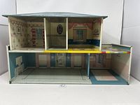 Front view showing two story layout with interior printed detail of rooms including wallpaper, furniture drawings, and flooring.