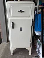 Front view of the vintage Westinghouse fridge showing white enamel finish, two compartment doors with metal handles and branding.