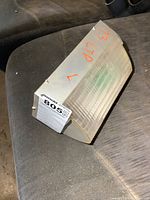 Clear signal light lens with orange reflector strip. Marked '73 LTD L' on side, shaped for vintage 1973 Ford LTD truck or car. Good structural condition, minor wear.