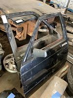 Exterior view of blue metal door with side mirror attached