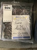 K&N air filter still in plastic bag with handwritten label indicating compatibility with Ford 2.3L engines from 1984-1992, part number KN33-2044.
