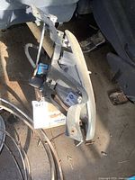 Used headlight assembly for 2004 Pontiac Montana showing mounting brackets and wiring connectors.