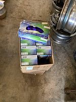 One open cardboard case with 10 boxes of Microflex Ultraform nitrile disposable gloves, size M.