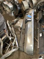 Chevrolet OBS front bumper and attached lower spoiler with surrounding automotive parts and tires.