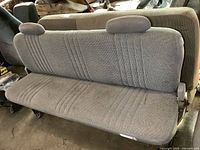 Front view of the gray fabric rear seat with two headrests and patterned upholstery for Chevrolet OBS truck.