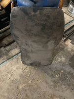 Top view of padded ATV type seat, showing worn and dirty fabric surface.