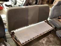 Photo showing rear fold down truck seat backrest in fabric, metal frame base without seat cushion