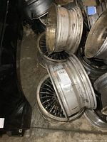 Four Western Wheels turbine style mag wheels of size 15x7 inches stacked and arranged, showing rims and turbine spoke design with heavy usage signs.