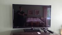 Front view of 46 inch LG TV turned off, reflecting room interior.