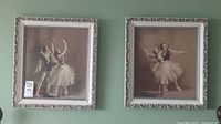 Two framed ballet art prints hanging on wall, each measuring 23x21 inches