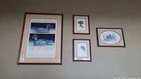 Four framed duck art prints displayed together on a wall, showing variety in size and framing.