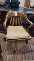 Front view of chair showing overall design, slat back and removable cushion