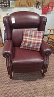 Front view of recliner with plaid cushion on seat
